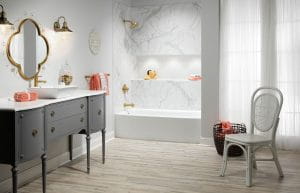 White bathtub-shower combination with marble walls and gold detailing.