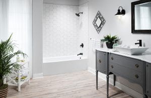White-tiled bathtub-shower combination with black detailing.
